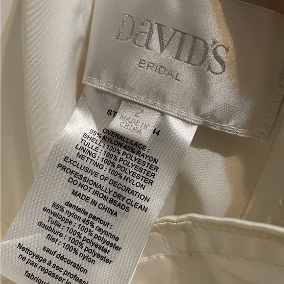 David's Bridal Lace Strapless Wedding Gown in the color “Ivory”. - Picture 2 of 16